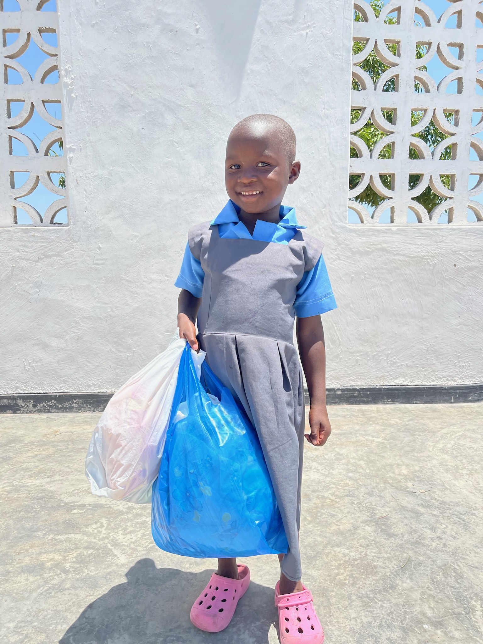 A sponsored child in Malawi with a gift